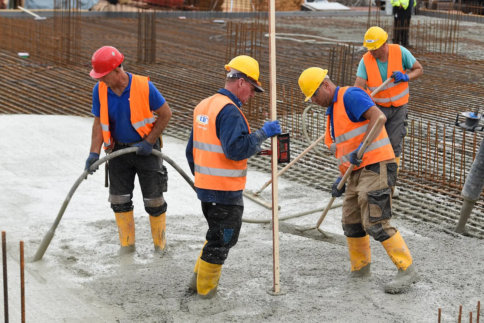 Concrete pour crew placing concrete on a reinforced slab